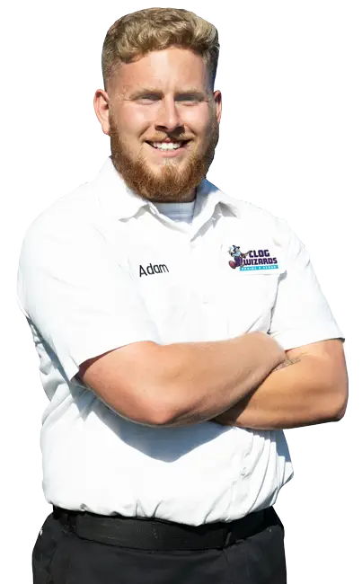 Adam, a professional drain-clearing technician from Clog Wizards, standing confidently in uniform.